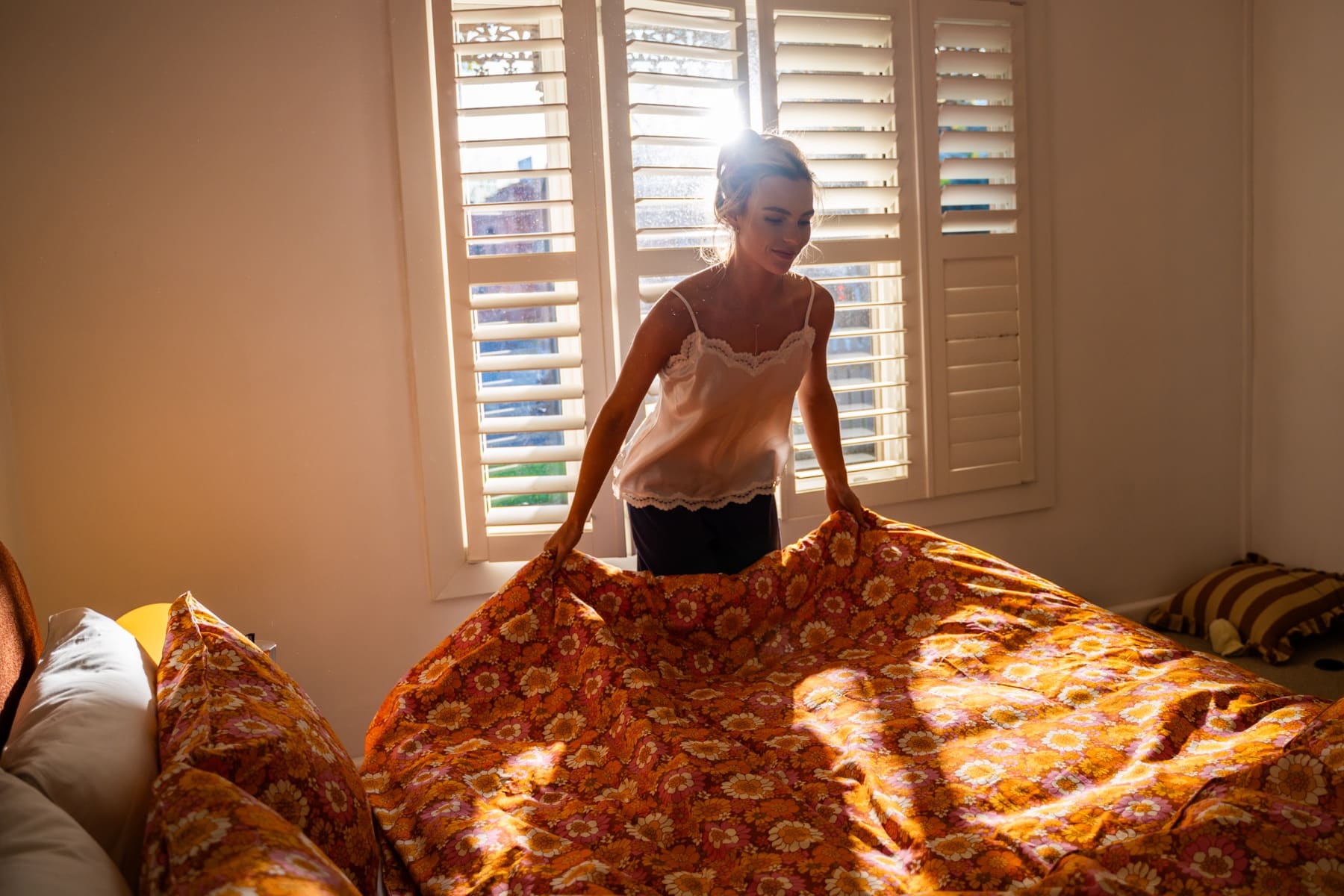 Making a bed with a Flower Child cotton quilt cover