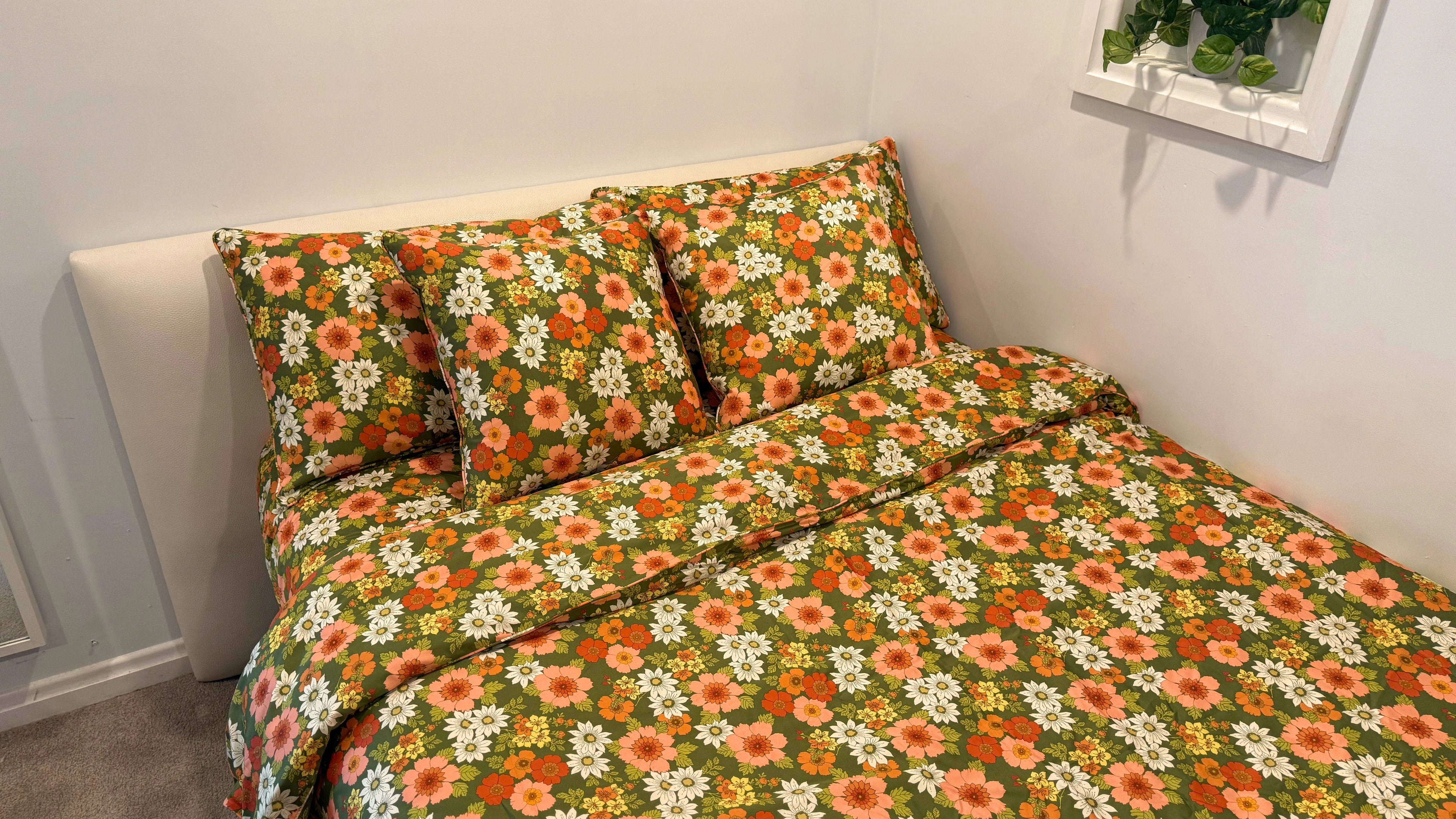 Wide view of a bed dressed in Mamma floral bedding with matching pillows