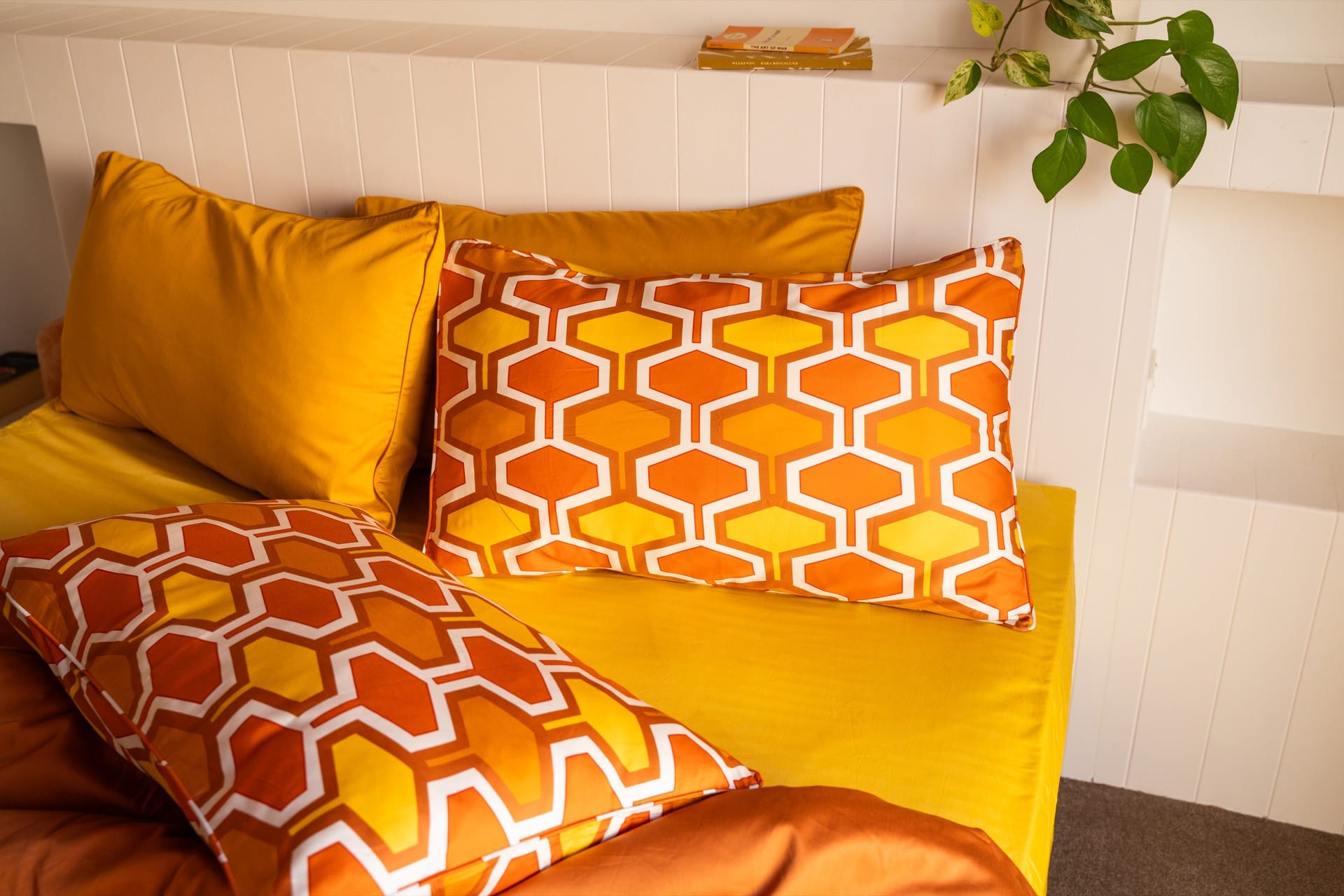 Wendy orange geometric pillowcases styled with golden yellow bedding