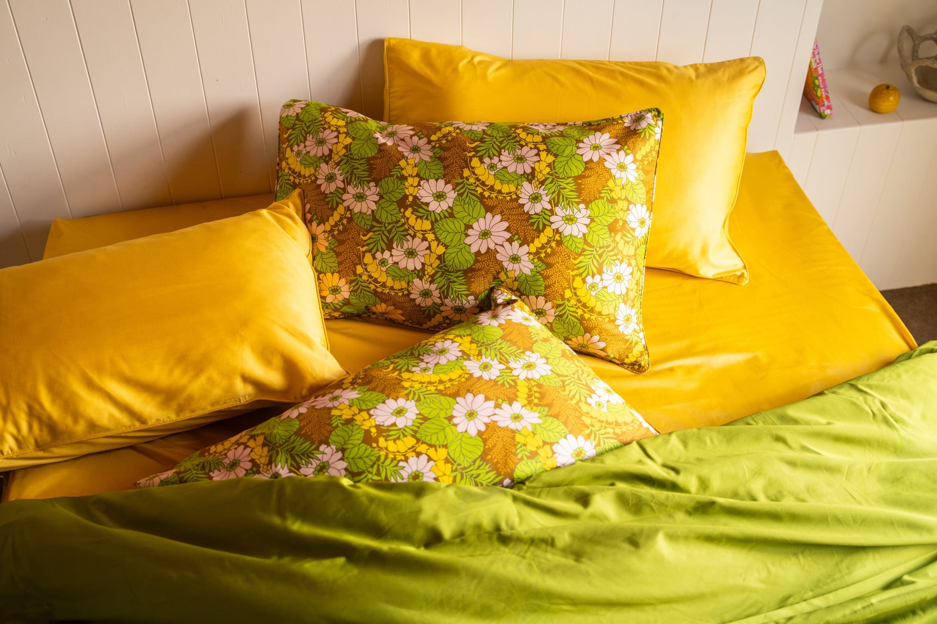 Sun Bell floral pillowcases styled with yellow and green bedding