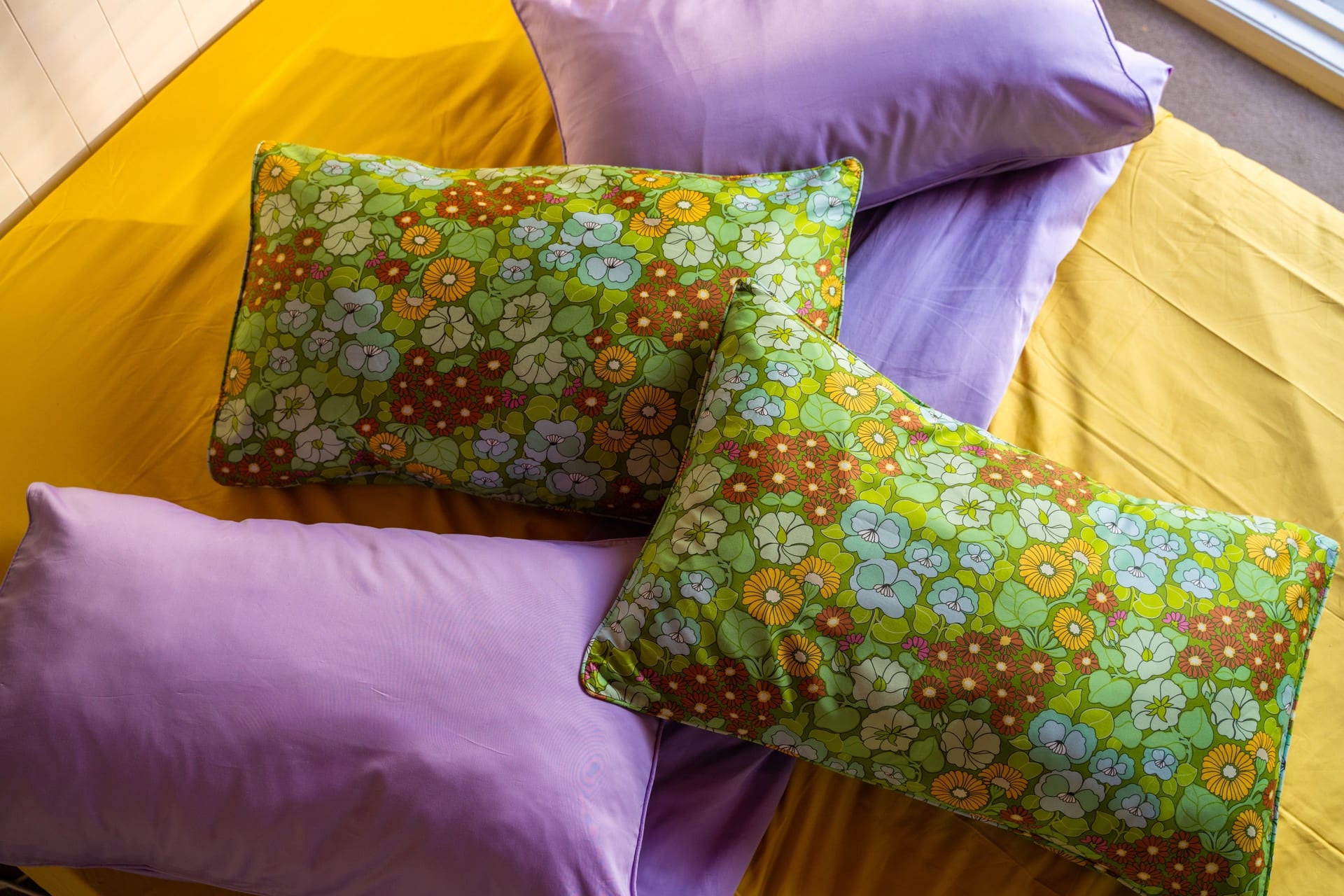 Isabelle floral pillowcases styled in a warm bedroom