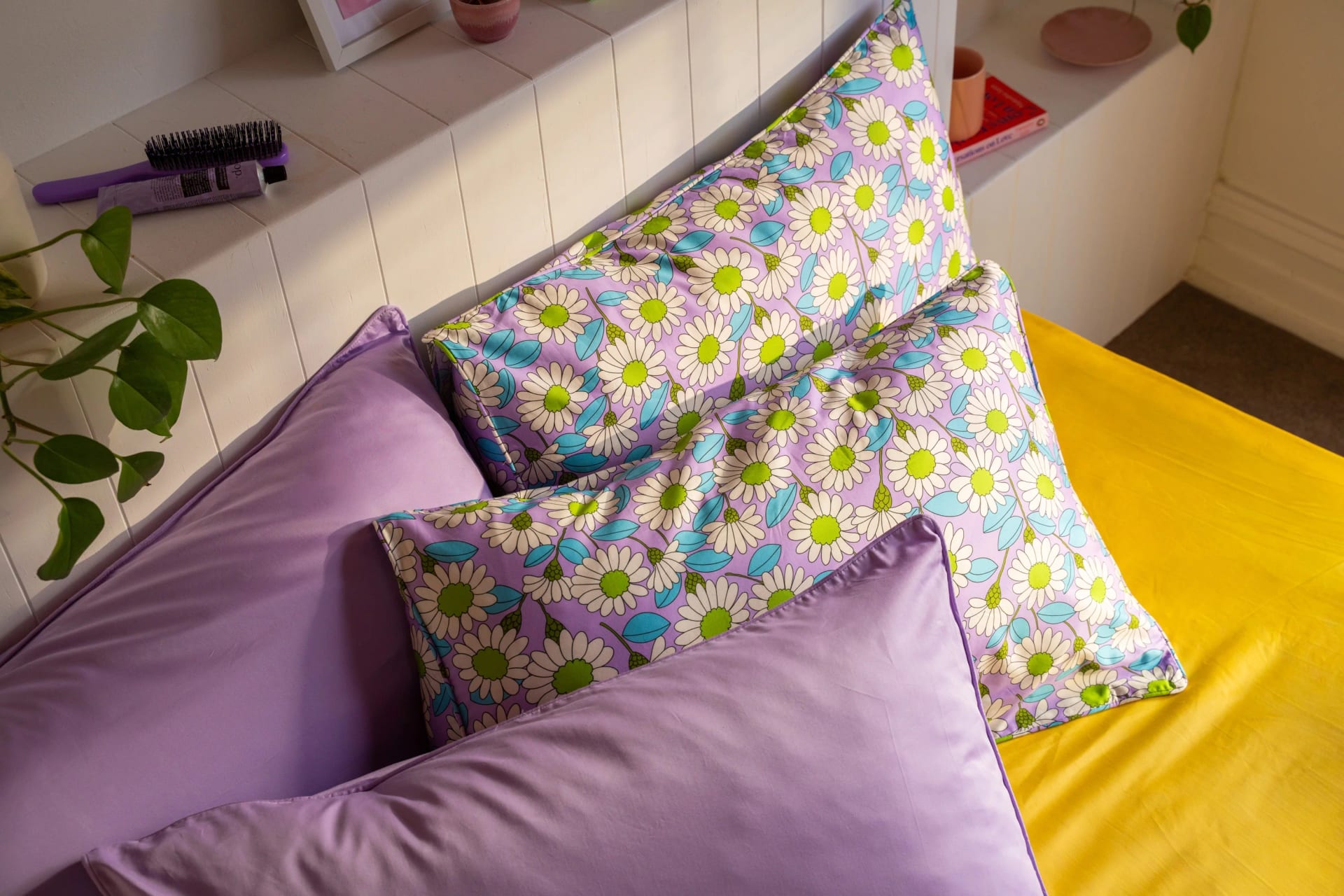 Lilac Daisy pillowcases styled with lilac bedding
